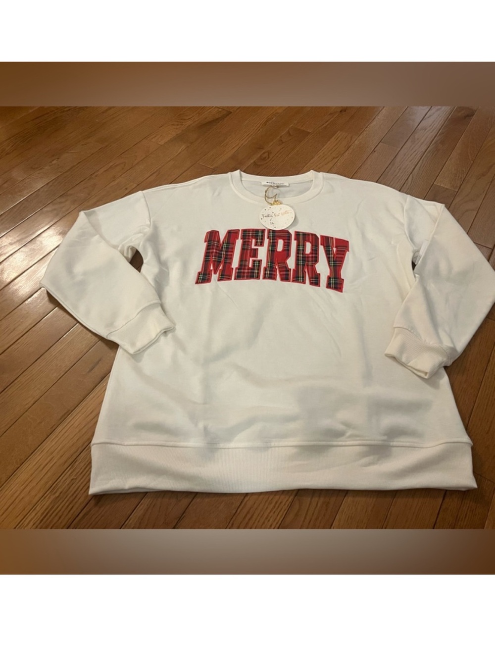 Oversized Cozy white sweatshirt featuring 'Merry' in red plaid letters .Sz MED
